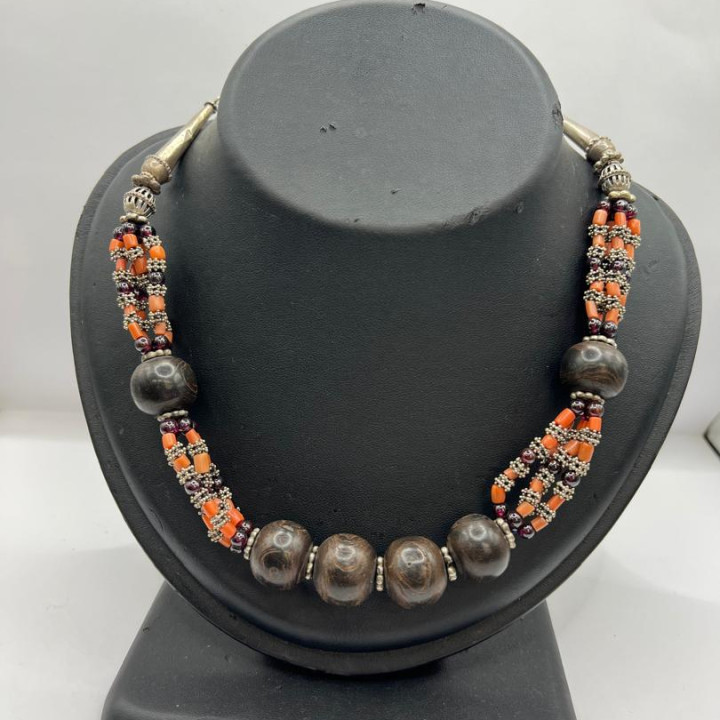 A royal silver necklace studded with precious stones and coral