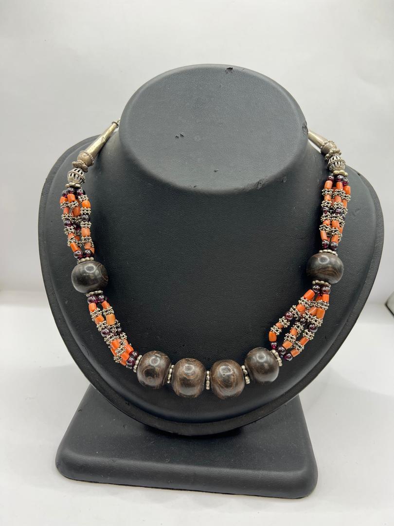 A royal silver necklace studded with precious stones and coral